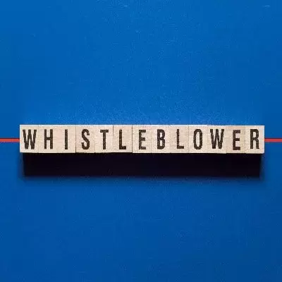 Whistleblower written in cubes on solid blue background.
