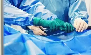 doctors in surgery tying off stent