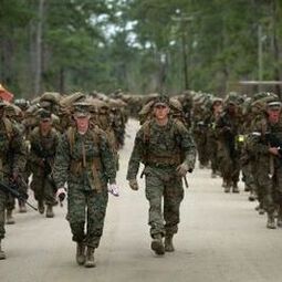 soldiers marching with backpacks on