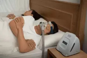 man sleeping with cpap mask on