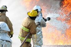 firemen using firefighting foam to put out a fire