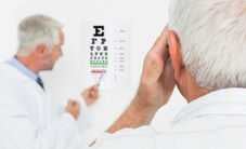 man looking at eye chart