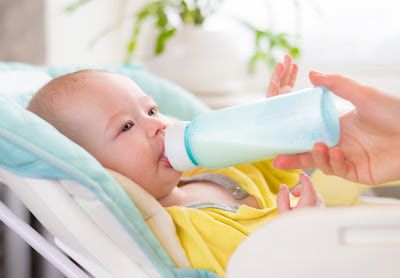 Baby being fed Cow milk-based infant formula products