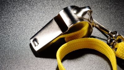 WHISTLE WITH YELLOW BAND LANYING ON CONCRETE